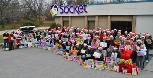 socket employees holding toys and wearing santa hats