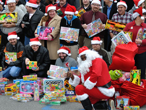 employees in santa hats with gifts