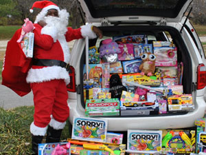 santa stands next to full van